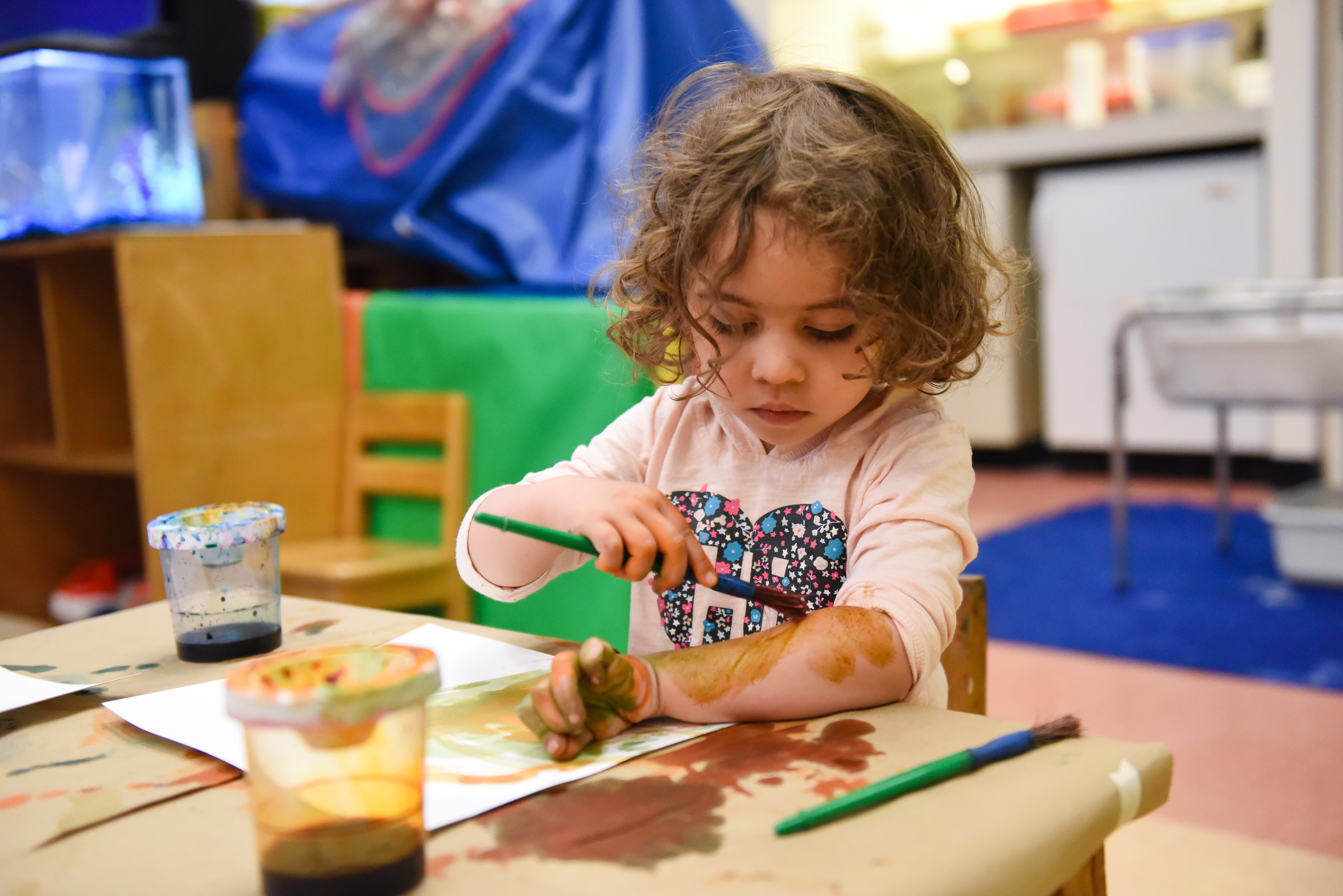 Girl painting her arm