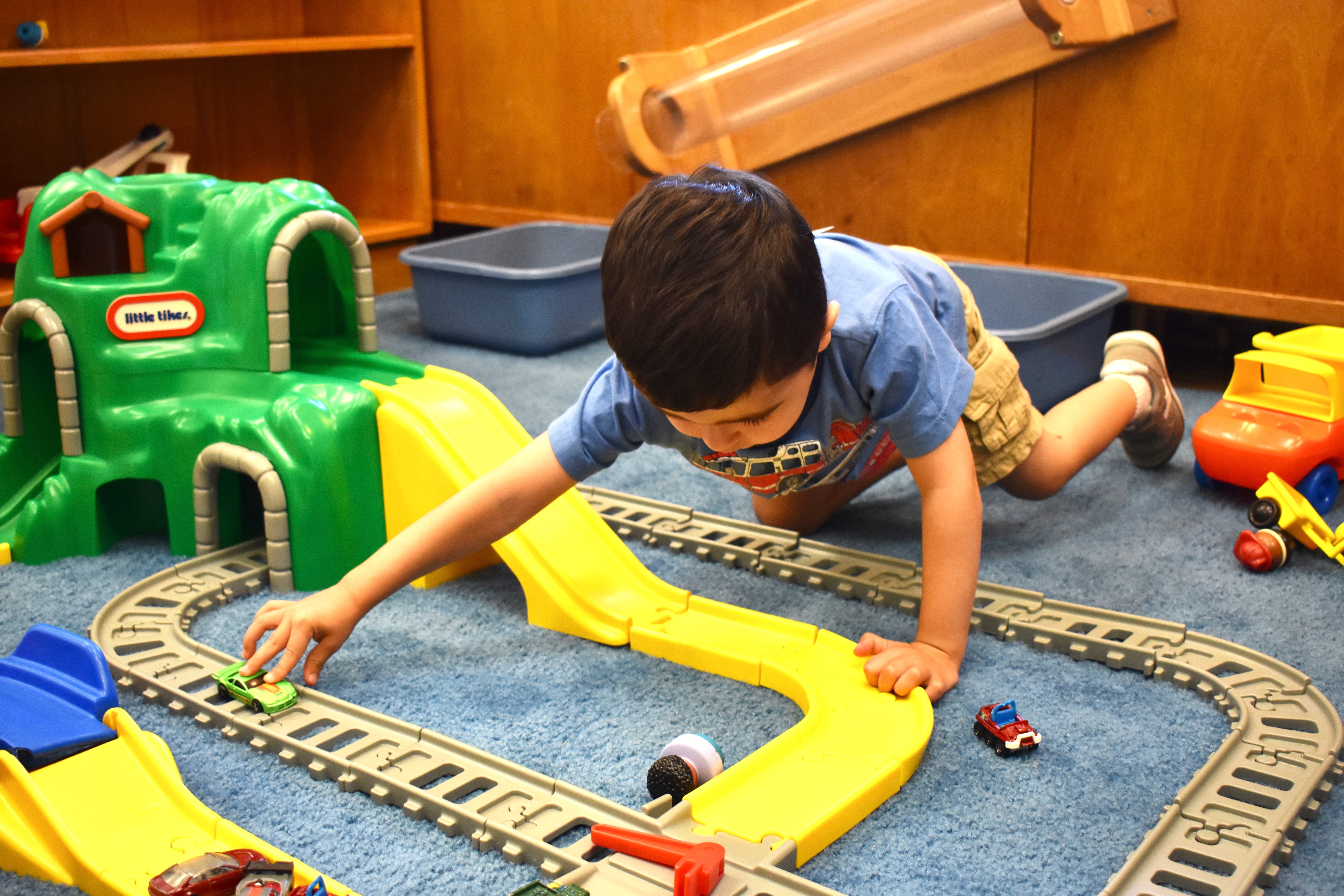 Boy with toy train track
